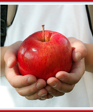 a student holding an apple